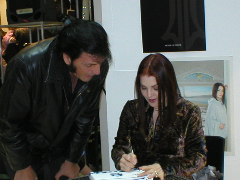 Priscilla Presley signs her autograph
