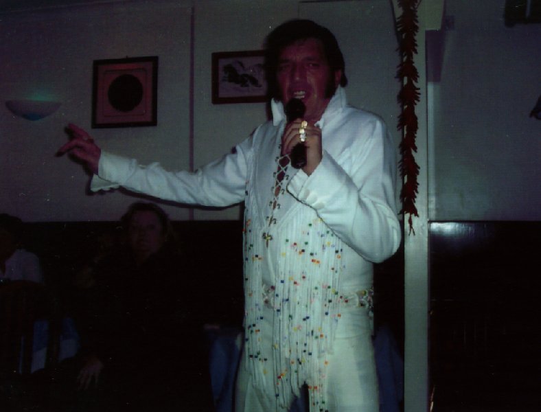 Paul performs live with white jumpsuit on